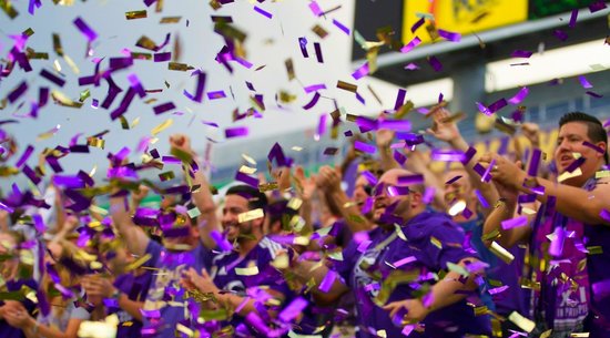 Fans cheer at an Orlando City Lions soccer game